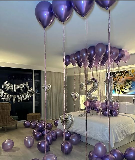 21st birthday suite with purple and silver balloon ceiling