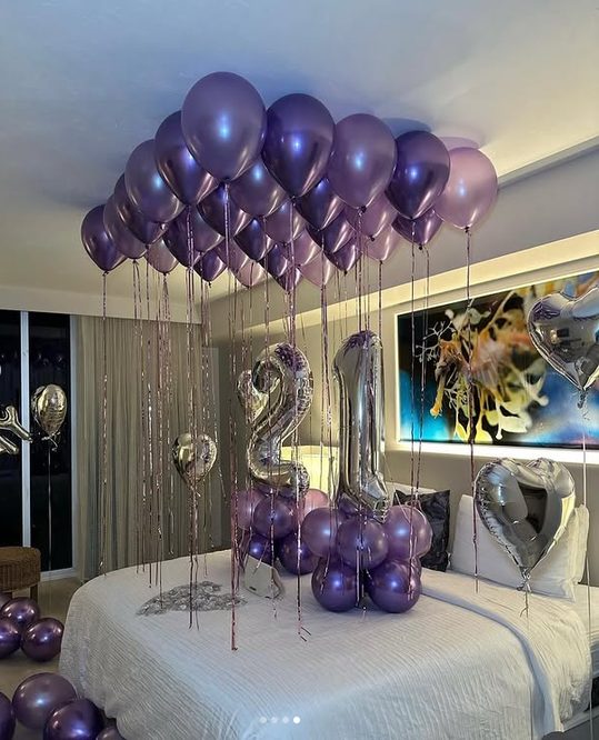 Floating purple balloon cloud ceiling installation